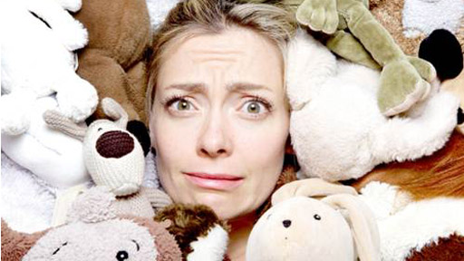 Cherry Healey covered in stuffed toys