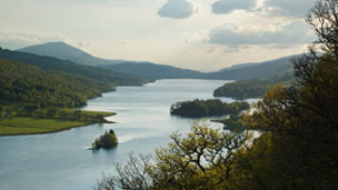 Colour view of Loch Tummel and surrounding hills with pointed peak of Schiehallion beyond