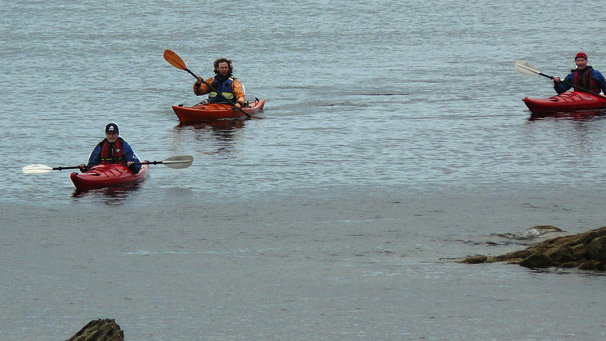 Three sea kayakers rounding the north end of Arran