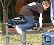 young man jumping over railings