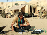 Jill McGivering with British troops behind her