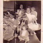 Me Margaret Maisey holding Georgie,I am wearing a white apron at nursery,with Sister Evans and Nurse Collins. Stoke on Trent - June 1943