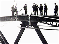 Workers on bridge span