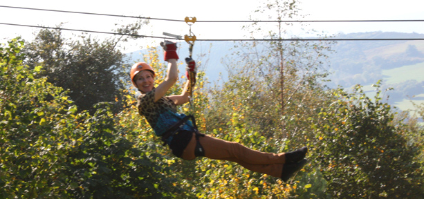 Naomi Wilkinson sliding down a zip wire