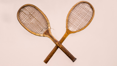 Two old wooden tennis racquets.