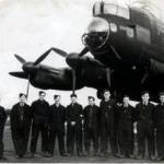 Ronald Derrick, RAF Engineer. Extreme left in front of Lancaster Bomber with bomb doors open.