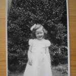 June on her 4th Birthday in the garden at the Crown and Sceptre in the dress supplied by the Airmen 1/6/44