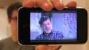 Man holding iPhone with image of Stephen Fry on it