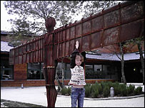 Girl at replica of Angel of the North in France.