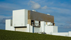 Sunny view of Torness Power Station on a grassy hillside.
