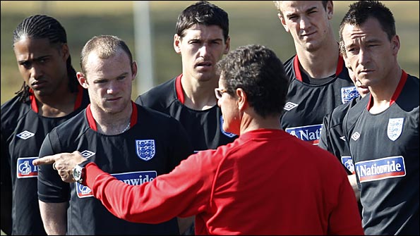 Fabio Capello talsk to his players in training