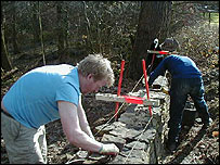 Men repair a wall