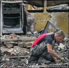A man searches the rubble of his house