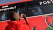 A boy takes a picture of a bus where Portugal player Deco can be seen through a window
