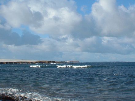 In a bright spell, Red Head on Eday can be seen from the Bay of Brough.