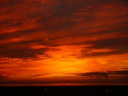 Sky on fire, sun sets in a defiant blaze over the Atlantic, viewed from Balivanich