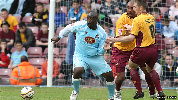 Adebayo Akinfenwa (left) in action for former club Northampton
