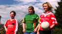 Three teenage sisters in Gaelic football kit