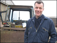 Man in front of tractor