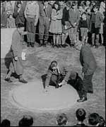 A black and white picture of men playing marbles