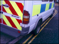 Police car parked on double yellow lines