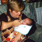 Lewis being fed at home by his mother Lynn