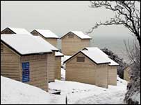 Ten snow-covered beach huts