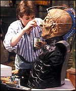 Re-touching Davros' make-up during filming