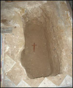 Simple wooden cross placed in grave