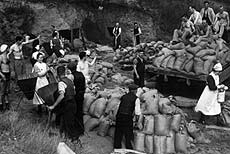 Sand from the caves being bagged up into sandbags.