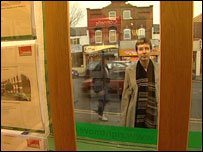 Lea Beven looking in window of estate agent