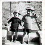 Photograph shows Frank Theaker (left) and his older brother George wearing Home Guard Helmets in the back garden of their home at 17 Daresbury Road, Sheffield in 1942.