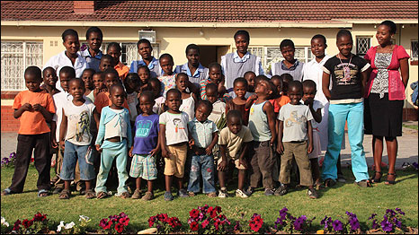 Mike Thomson with children at the Shengu Dzevena home