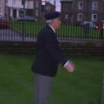 Remembrance Sunday, November 2004. Pat Kelly, one of five siblings who served in the Armed Forces during World War Two lays a poppy wreath and salutes to remember fallen comrades at the World War Two Memorial, St Begh's Church, Coach Road, Whitehaven, Cumbria.