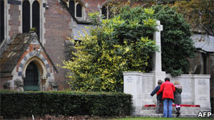 Mother with two children at war memorial