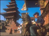 Boy sitting outside a temple in Nepal