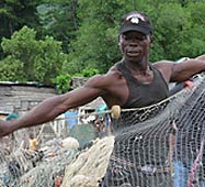 Fisherman with net in Tombo village, Sierra Leone