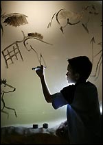 A child painting on rock