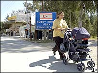 Kuzey Kıbrıs Türk Cumhuriyeti tabelasının önünden geçmekte olan bir kadın
