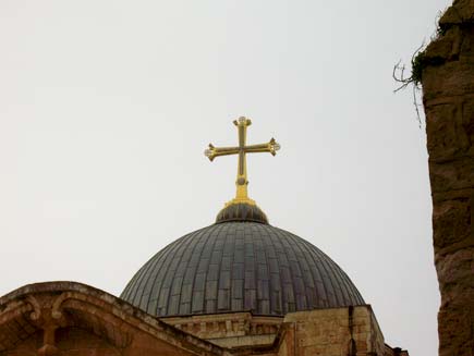 Domed church roof with a golden Christian cross at the apex