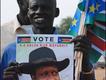 A Supporter of Salva Kiir holds a placard 