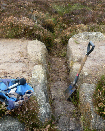 Spade propped up in cleared-out drain