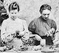 Two Victorian woman at work in a hat factory