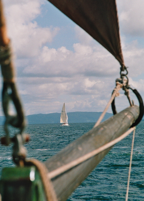 Niki in the distance, with the Swans bowsprit and jib in the foreground.