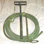 Stirrup Hand-pump with dual jet and spray nozzle. Used to extinguish the Magnesium {Electron) bomb (incendiary bomb). 30 feet of hose could be used by fire-guards at a safe distance from heat and fire. A jet of water could be fired from 30 feet or as a spray at 15 feet.