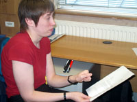 Liz Ball looks in frustration at a sheet of paper