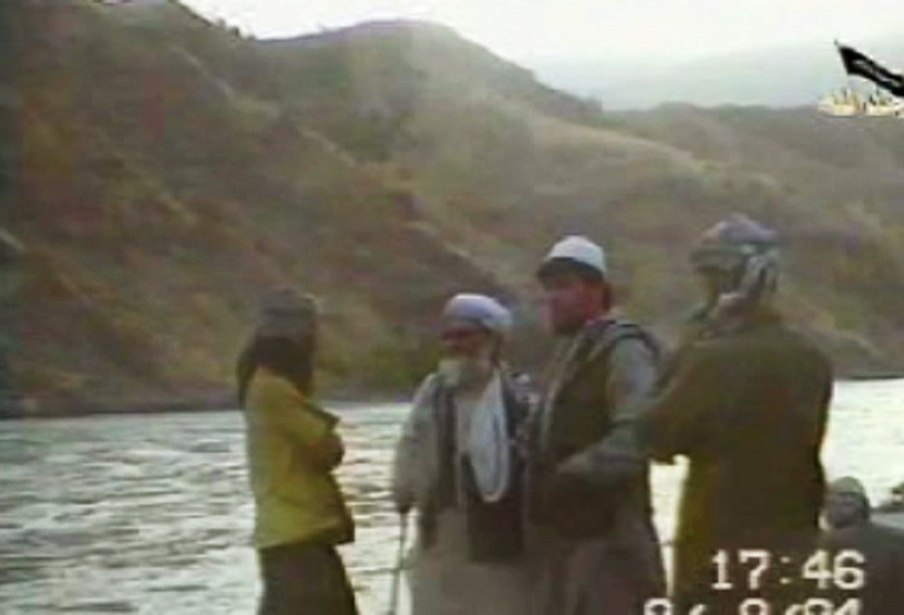 Tahir Yuldash by a river with Ayman az-Zawahiri (al -Quadia no. 2 ) on his right.