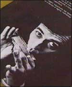 A photograph of Brian playing the harmonica 