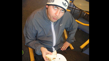 Mike Balls eating a bacon sandwich