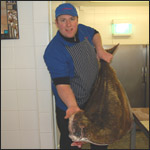 Robert holding up a very large halibut